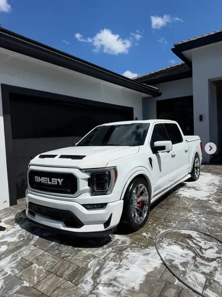A white Shelby F-150 in fresh suds on a paver driveway