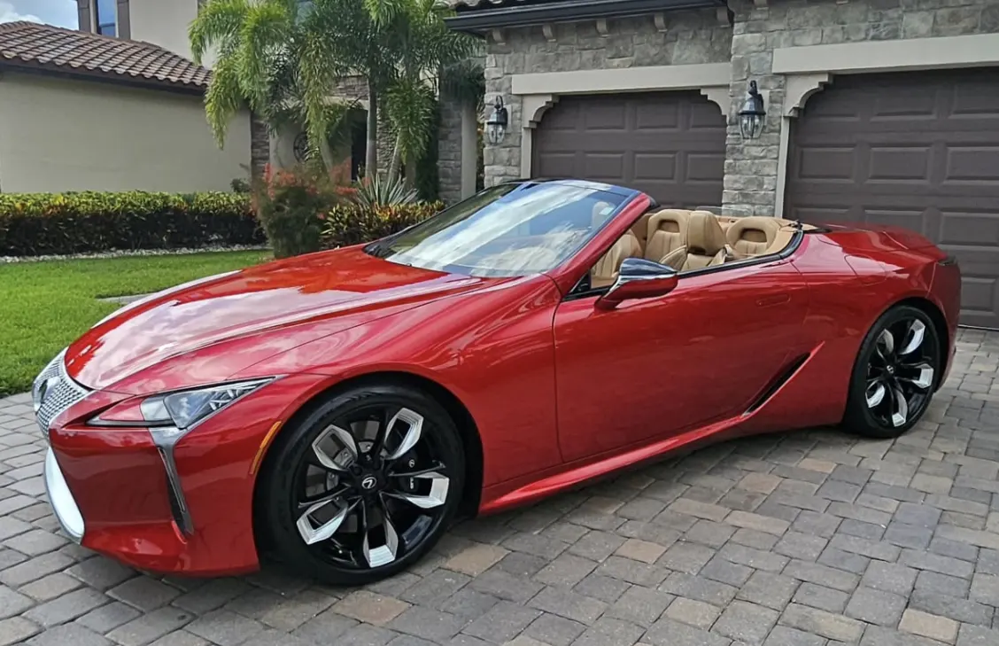A red Lexus convertible, detailed in the owner’s driveway